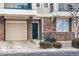 Inviting townhome facade with brick accents, a single car garage, and a welcoming front door at 1861 Mallard Dr, Superior, CO 80027