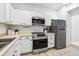 Modern kitchen featuring stainless steel appliances, white cabinetry, and ample counter space at 1861 Mallard Dr, Superior, CO 80027