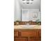 Bathroom features a coordinated sink and vanity with decorative mirror and lighting at 1155 N Ash St # 102, Denver, CO 80220