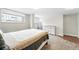 Bright bedroom with large windows, neutral walls, carpet, and a dresser at 1155 N Ash St # 102, Denver, CO 80220
