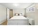 This bedroom features neutral paint and carpet with a large window for natural light at 1155 N Ash St # 102, Denver, CO 80220