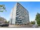 Apartment building with modern design and a blue and white color scheme, complemented by lush surrounding trees at 1155 N Ash St # 102, Denver, CO 80220