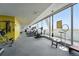 Bright gym with floor-to-ceiling windows with treadmills, stationary bike and weight machines at 1155 N Ash St # 102, Denver, CO 80220