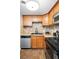 Well-lit kitchen features wood cabinetry, granite countertops, stainless appliances, and decorative backsplash at 1155 N Ash St # 102, Denver, CO 80220