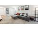 Open living room with sectional sofa, decor and artwork creating a welcoming and stylish space for relaxation at 1155 N Ash St # 102, Denver, CO 80220