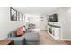Inviting living room with a sectional sofa, television, stylish shelving, and a functional desk area at 1155 N Ash St # 102, Denver, CO 80220