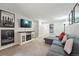 Living room featuring modern decor, TV and comfortable sectional sofa offering a stylish and relaxing atmosphere at 1155 N Ash St # 102, Denver, CO 80220