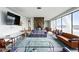Bright living room features large windows, stone fireplace, and contemporary furnishings at 1155 N Ash St # 102, Denver, CO 80220