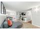 Cozy living room featuring a sectional sofa, TV, fireplace, and desk area for a comfortable and functional space at 1155 N Ash St # 102, Denver, CO 80220