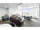 Spacious living room features an open layout and large windows with city views at 1155 N Ash St # 102, Denver, CO 80220
