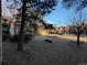 Exterior photo of a building featuring mature trees and rock landscaping in the courtyard at 14751 E Tennessee Dr # 213, Aurora, CO 80012