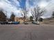 Exterior view of a parking lot with several parked cars in front of the building, showcasing the convenient parking for residents at 14751 E Tennessee Dr # 213, Aurora, CO 80012