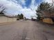 Street view showing the complex exterior and road with parking, illustrating the neighborhood and accessible parking at 14751 E Tennessee Dr # 213, Aurora, CO 80012