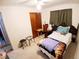 Comfortable bedroom with beige carpet, a ceiling fan and two side tables at 8338 Charles Way, Denver, CO 80221
