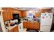 Efficient kitchen featuring ample counter space, wood cabinets, and white appliances at 8338 Charles Way, Denver, CO 80221