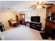 Cozy living room featuring a fireplace, dining area, and neutral carpeting at 8338 Charles Way, Denver, CO 80221