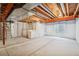 Unfinished basement with concrete floor and exposed ceiling, offering potential for customization and storage space at 12827 W Burgundy Pl, Littleton, CO 80127