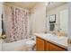 Functional bathroom featuring a tub with shower, vanity with sink, and neutral decor, providing essential amenities at 12827 W Burgundy Pl, Littleton, CO 80127
