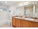Spacious bathroom features double sinks, a large mirror and vanity plus tub and toilet at 12827 W Burgundy Pl, Littleton, CO 80127