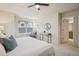 Bright bedroom features a ceiling fan, large window and a modern workstation near the bathroom at 12827 W Burgundy Pl, Littleton, CO 80127