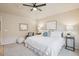 This neutral bedroom offers plush carpet, ceiling fan, and comfortable furniture for relaxation at 12827 W Burgundy Pl, Littleton, CO 80127