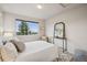 Bright bedroom features large window, neutral tones, and stylish decor, creating a cozy and inviting atmosphere at 12827 W Burgundy Pl, Littleton, CO 80127