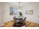 Cozy dining area featuring hardwood floors, a stylish chandelier, and comfortable seating at 12827 W Burgundy Pl, Littleton, CO 80127