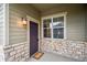 Charming entryway features a stone facade, stylish light fixture, and well-maintained front door, creating a welcoming entrance at 12827 W Burgundy Pl, Littleton, CO 80127