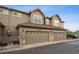 Exterior view of a townhome featuring a two-car garage and well-maintained landscaping, enhancing curb appeal at 12827 W Burgundy Pl, Littleton, CO 80127