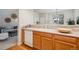Updated kitchen with a view into the living room and stainless steel appliances at 12827 W Burgundy Pl, Littleton, CO 80127