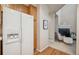 Kitchen with white refrigerator and storage cabinets that flows to the living room at 12827 W Burgundy Pl, Littleton, CO 80127