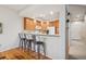 Open kitchen featuring wood cabinets, recessed lighting, breakfast bar with seating, and hardwood floors at 12827 W Burgundy Pl, Littleton, CO 80127