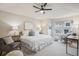 Serene main bedroom with plush carpeting, a ceiling fan, and ample natural light at 12827 W Burgundy Pl, Littleton, CO 80127
