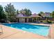 Community pool area with a swimming pool, cabana and lounge chairs, creating a refreshing and social atmosphere at 12827 W Burgundy Pl, Littleton, CO 80127