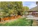 Landscaped backyard with a wooden fence and mature trees at 9441 Wolfe St, Highlands Ranch, CO 80129