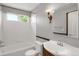 Clean bathroom with a single sink and shower/tub combo at 9441 Wolfe St, Highlands Ranch, CO 80129
