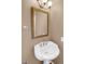Small bathroom with pedestal sink and decorative mirror at 9441 Wolfe St, Highlands Ranch, CO 80129