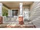 Covered porch with white railing, brick base, and front door at 9441 Wolfe St, Highlands Ranch, CO 80129