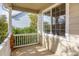 Covered porch with white railing, brick base, and window at 9441 Wolfe St, Highlands Ranch, CO 80129