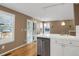 Kitchen with white cabinets, stainless steel dishwasher, and access to patio at 9441 Wolfe St, Highlands Ranch, CO 80129