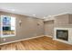 Bright living room with hardwood floors and a fireplace at 9441 Wolfe St, Highlands Ranch, CO 80129