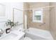 Bright bathroom featuring a shower-over-tub, vanity with modern fixtures, and neutral color palette at 5680 W 41St Ave, Wheat Ridge, CO 80212