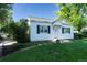 Charming home with a well-manicured lawn and mature trees at 5680 W 41St Ave, Wheat Ridge, CO 80212