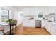 Bright kitchen featuring stainless steel appliances, quartz countertops, and wood flooring at 5680 W 41St Ave, Wheat Ridge, CO 80212