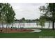 Community playground by the lake with picnic tables, swings, and a paved path for Gathering fun and recreation at 5680 W 41St Ave, Wheat Ridge, CO 80212