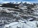 Panoramic aerial shot of a snow-covered landscape featuring a home, barn, and mountains in the background at 300 Gold Hill Rd, Breckenridge, CO 80424