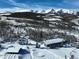 A wintery aerial view of an estate nestled in a picturesque, snow-covered mountain landscape at 300 Gold Hill Rd, Breckenridge, CO 80424