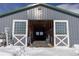 Interior view of horse barn with sliding doors, horse stalls, and ample workspace at 300 Gold Hill Rd, Breckenridge, CO 80424