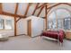 Bright bedroom with exposed wooden beams, neutral carpet, and natural light from a lovely arched window at 300 Gold Hill Rd, Breckenridge, CO 80424