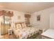 Bedroom with a metal frame bed, decorative linens, neutral walls and tile flooring at 300 Gold Hill Rd, Breckenridge, CO 80424